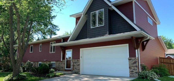 Fully renovated home exterior featuring a new upper extension with modern windows and a refreshed facade.